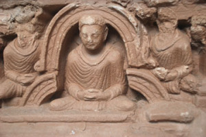 A stupa niche decorated with a stucco figure of the Buddha at the Jaulian monastery, Taxila