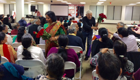 Executive members Pratima Shah and Chiman Patel present flowers as  Valentine's Day greeting