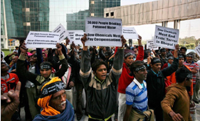 File photo of activists and survivors of the 1984 Bhopal gas leak disaster that killed and harmed thousands hold placard again Dow Chemical Company outside it's office in Noida, on the outskirts of  New Delhi, India, November 19, 2009