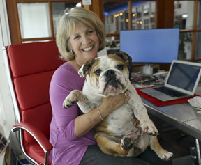 In this Tuesday, Oct. 18, 2016, photo, Barbara Goldberg, CEO of O'Connell & Goldberg Public Relations, poses for a photograph with her bulldog Rosie, at her office in Hollywood, Fla. Goldberg is a small business owner who believes pets improve the quality of their work life, boosting morale and easing tension for staffers. (AP Photo/Lynne Sladky)