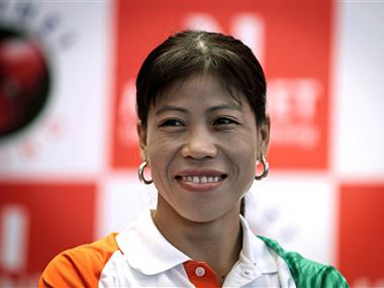 FILE - In this July 22, 2012 file photo, Indian boxer M.C. Mary Kom smiles during a press conference in New Delhi, India.  India's star woman boxer M.C. Mary Kom is not surprised at the crowd support for her at the Asian Games. The sprightly 31-year-old acknowledges cheers from the stands and does not even mind being pushed around as her fans jostle with each other to get pictured with her. (AP Photo/Saurabh Das, File)