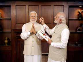 New Delhi: Prime Minster Narendra Modi with his wax statue due to be placed at Londons Madame Tussauds museum, in New Delhi. Three of his wax statues have been installed in Singapore, Hong Kong and Bangkok and one of them will be put up in London in the next eight days. PTI Photo / Madame Tussauds(PTI4_20_2016_000178B)