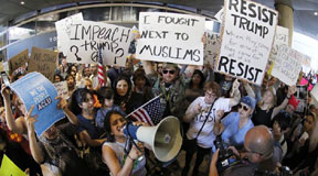 Demonstrators gather outside Tom Bradley International Terminal as protests against President Donald Trump's executive order banning travel from seven Muslim-majority countries continue at Los Angeles International Airport Sunday, Jan. 29, 2017. (AP Photo/Ryan Kang)
