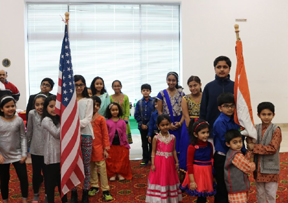 Children unfurling the national flags of USA and India 