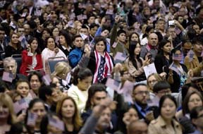 people wave U.S. flags during a naturalization ceremony at the Los Angeles Convention Center, in Los Angeles. Since Trump’s immigration enforcement order and travel ban, immigrants have been rushing to prepare applications to become Americans. Advocates in Los Angeles, Maryland and New York catering to diverse immigrant communities from Latin America, Asia and the Middle East all said they’ve been fielding a rising number of questions about how to become a U.S. citizen.