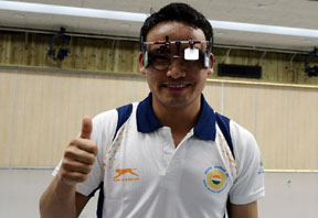 India's Jitu Rai gestures after winning the men's 50m pistol individual final of the 2014 Asian Games in Incheon on September 20, 2014. Jitu Rai of India won the gold with Hoang Phuang Nguyen of Vietnam and China's Wang Zhiwei taking the silver and bronze respectively.  AFP PHOTO/ MANAN VATSYAYANA / AFP PHOTO / MANAN VATSYAYANA