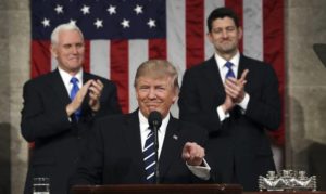 President Donald Trump, flanked by Vice President Mike Pence and House Speaker Paul Ryan of Wis., gestures on Capitol Hill in Washington, Tuesday, Feb. 28, 2017, before his address to a joint session of Congress. (Jim Lo Scalzo/Pool Image via AP)