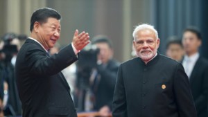 Chinese President Xi Jinping left welcomes Narendra Modi for a meeting at the SCO