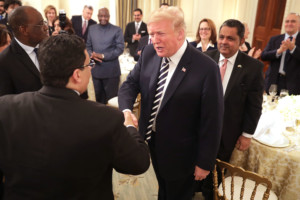 President Donald Trump greets guests while hosting an Iftar dinner