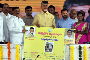 Andhra Pradesh Chief Minister N Chandhrababu Naidu distributing house allotment papers and new clothes to the beneficiaries