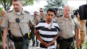 Cristhian Bahena Rivera is escorted into the Poweshiek County Courthouse for his initial court appearance