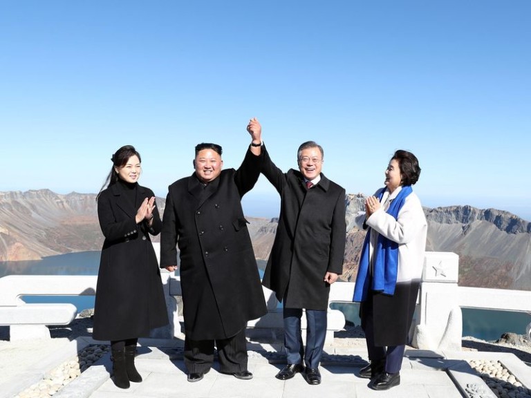 Kim Moon joins hands on peak of sacred North Korean volcano