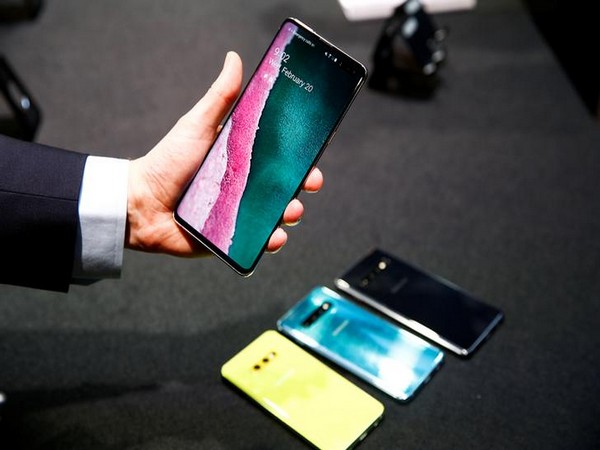 A journalist holds the new Samsung Galaxy S10 smartphone at a press event in London