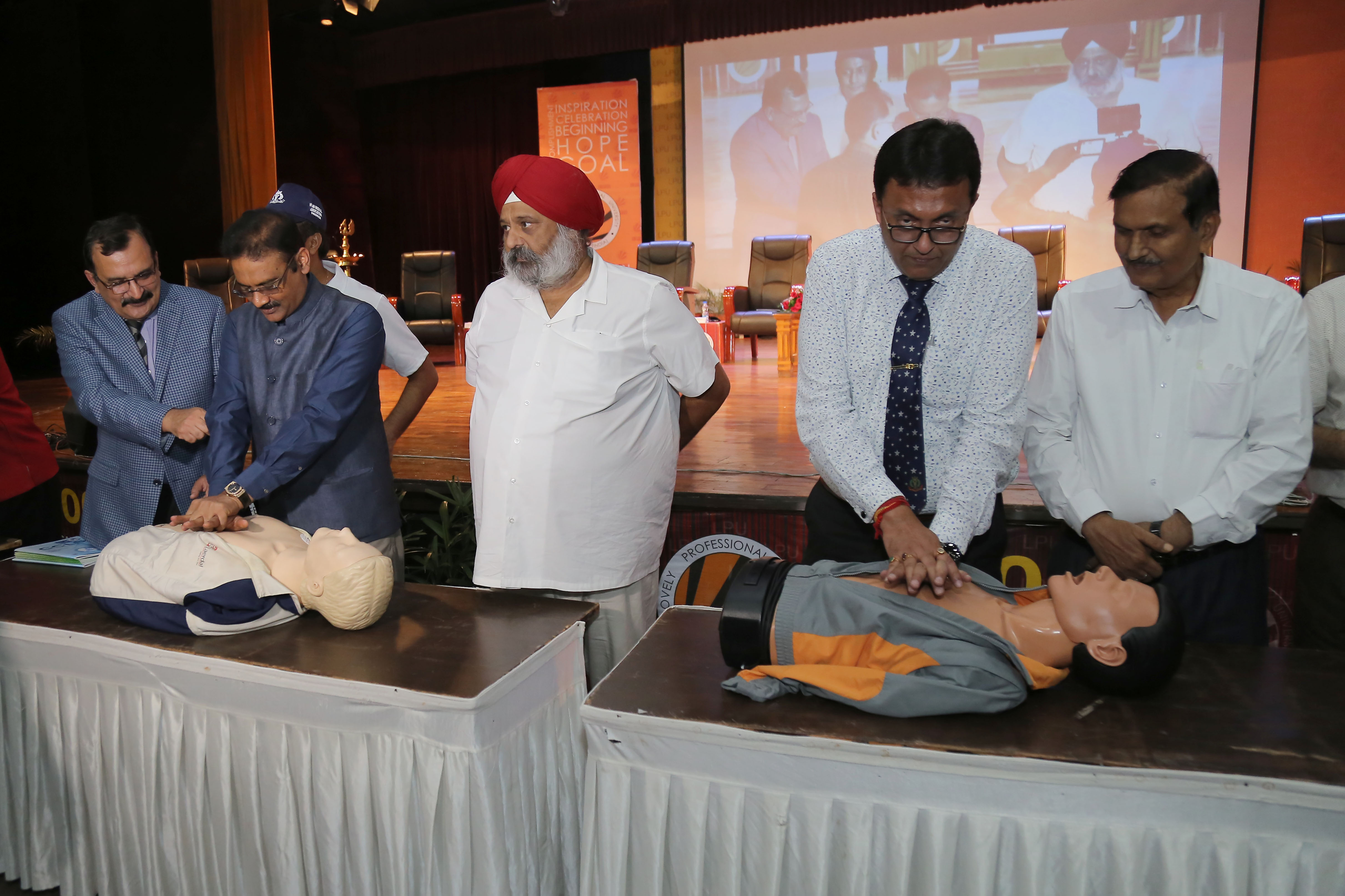 IMA President Dr Santanu Sen and LPU Chancellor Mr Ashok Mittal applying 'compression' technique on mannequins at LPU during International CPR Day Celebration
