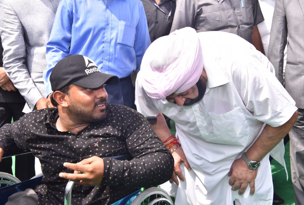 Punjab Chief Minister Captain Amarinder Singh interacts with a physically challenged person