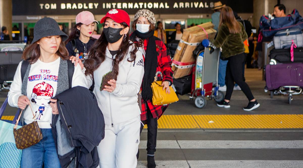 Arriving passengers wear face masks at Los Angeles International Airport on Tuesday, Jan. 21, 2020. (Alex Welsh/The New York Times)