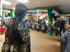 Tibetan women form a circle to dance "Gorshe" dance at the Tibetan Alliance of Chicago in Evanston, IL.