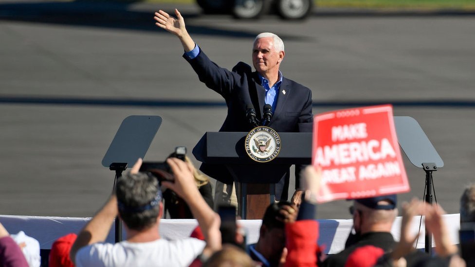 Pence stays campaigning despite aide's Covid-19 diagnosis