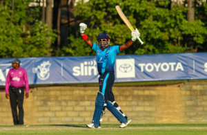 20211003 Narsingh Deonarine raises his bat to the crowd for 50 full frame uncropped