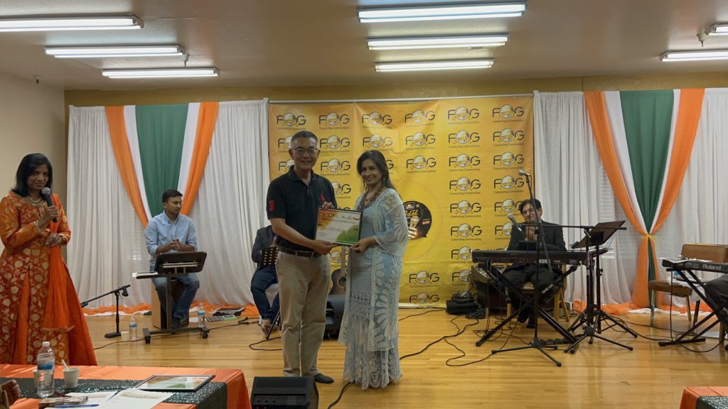 Alpana Sharma (right) receiving a Certificate of Appreciation from Assemblymember Kansen Chu