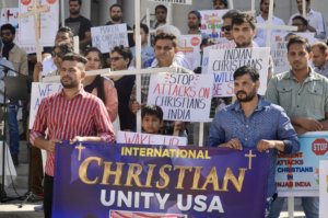 Protestors holding the banner of the International Christianity Unity USA association