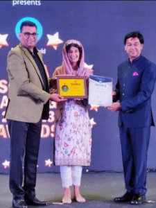 Sarah Shah receiving a philanthropy school award for Turtuk Valley School from The Education World Magazine. India No.7 and Ladakh No.1