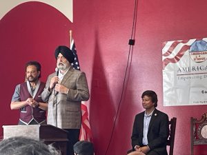 Attorney Jaspreet Singh addresses the gathering as Dr. Japra (left) and Shri Thanedar (right) look on