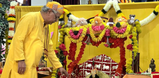 Pt Joshi Ji swinging Lord Krishna in a Hindola