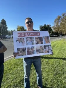 A man holds up a poster with pictures of some of the Hamas kidnapping victims