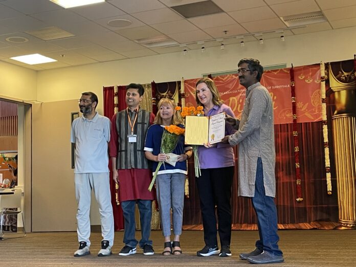 Santa Clara Mayor Lisa Gillmor (second from right) and Councilmember Kathy Watanabe (third from right) being honored by Prakash Giri (far right). Also on stage Ashish Garg (far left) and Ravi Narayan