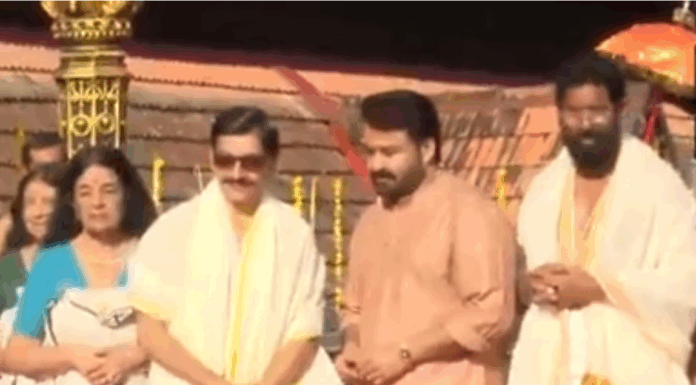 Mohanlal receives Vilambara Pathrika from Travancore royal family members Mohanlal